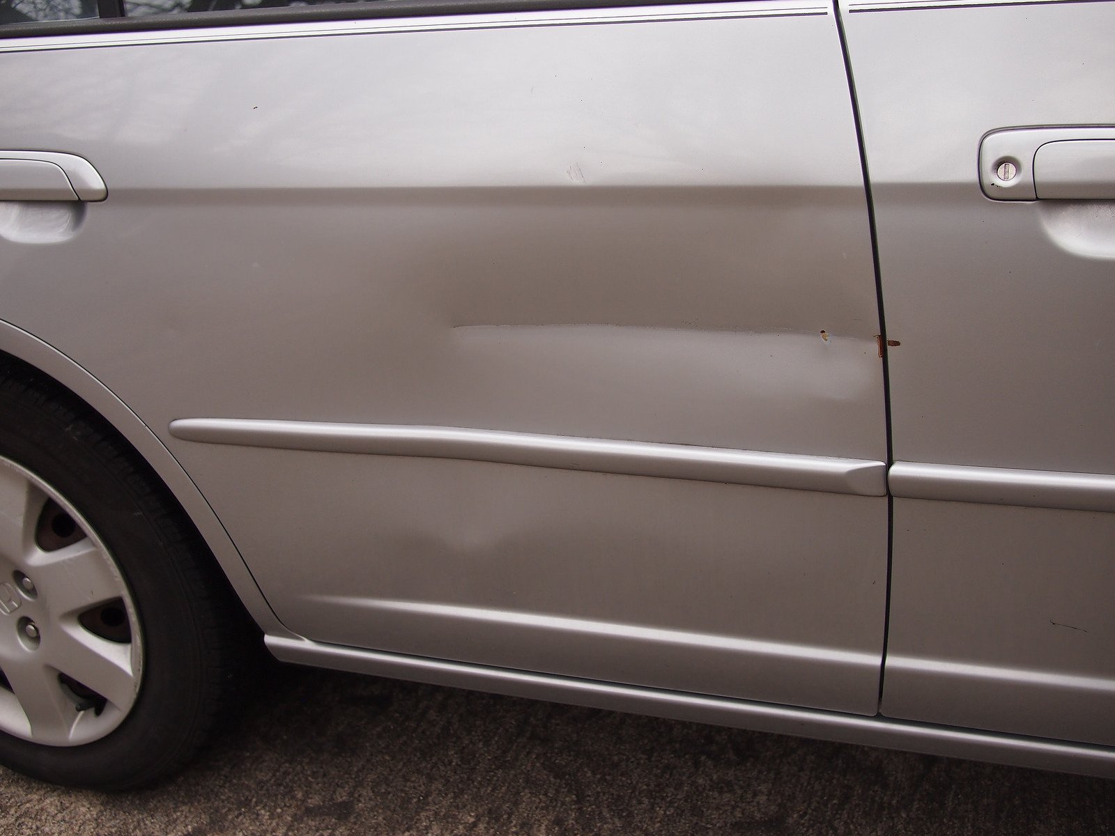 Is it worth filing a car insurance claim for a dented door?